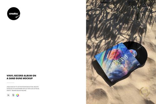 Top view of a vinyl record album mockup on a sunlit sand dune, featuring vibrant artwork and natural shadows.