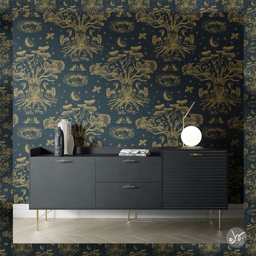 Interior wallpaper mockup showing a dark sideboard against a wall with whimsical gold forest patterns on a deep blue background.