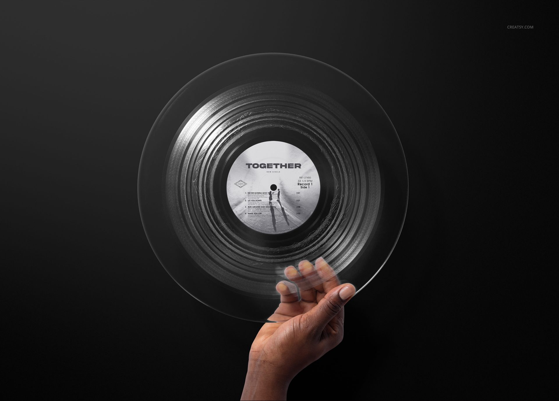 Clear vinyl record mockup with a hand grasping the edge, displaying the central label and black background.