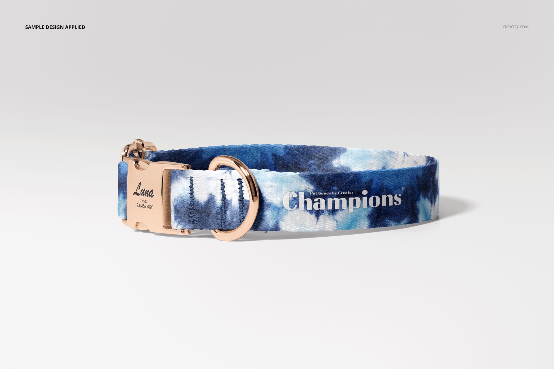 Front view of a dog collar mockup featuring blue and white abstract pattern and metallic gold buckle on a plain backdrop.