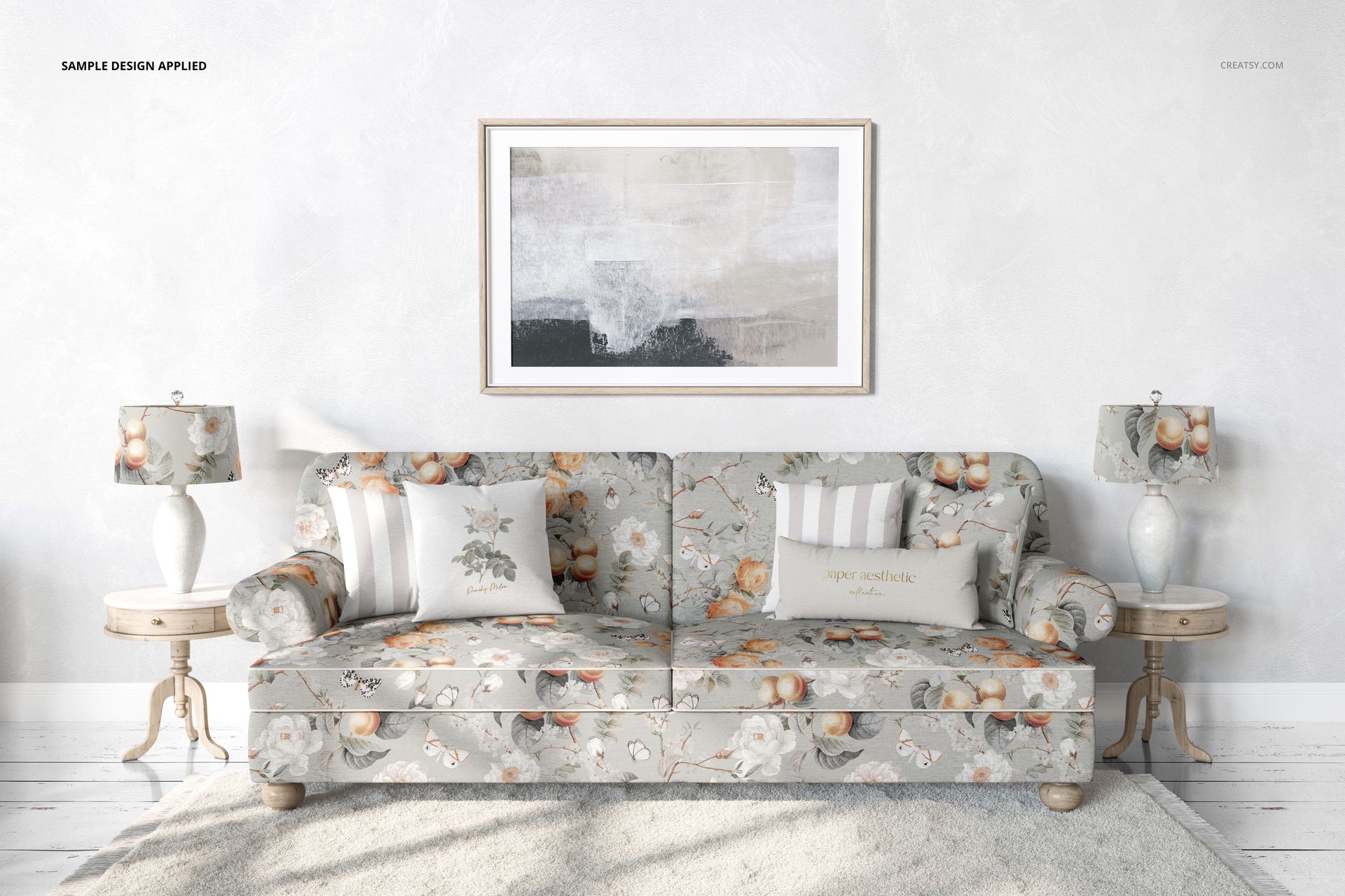 PSD mockup showing a sofa with floral pillows and upholstery, two side tables with lamps, and a textured rug in a bright room.