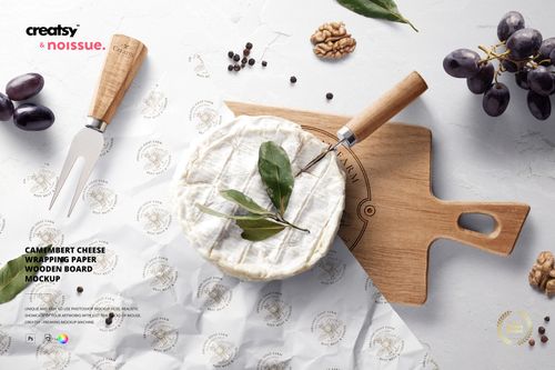 Mockup scene featuring camembert cheese, wooden cutting board, wrapping paper, and food props arranged on a white surface.