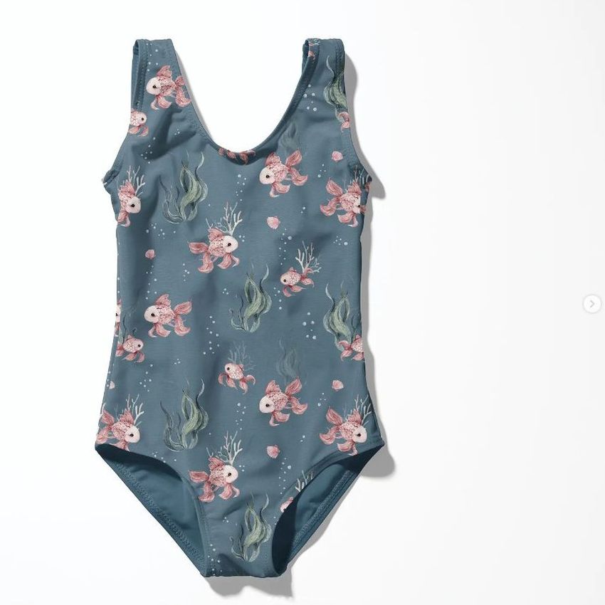 Baby swimsuit mockup featuring a blue one-piece with a playful undersea pattern of fish and seaweed on a white background.