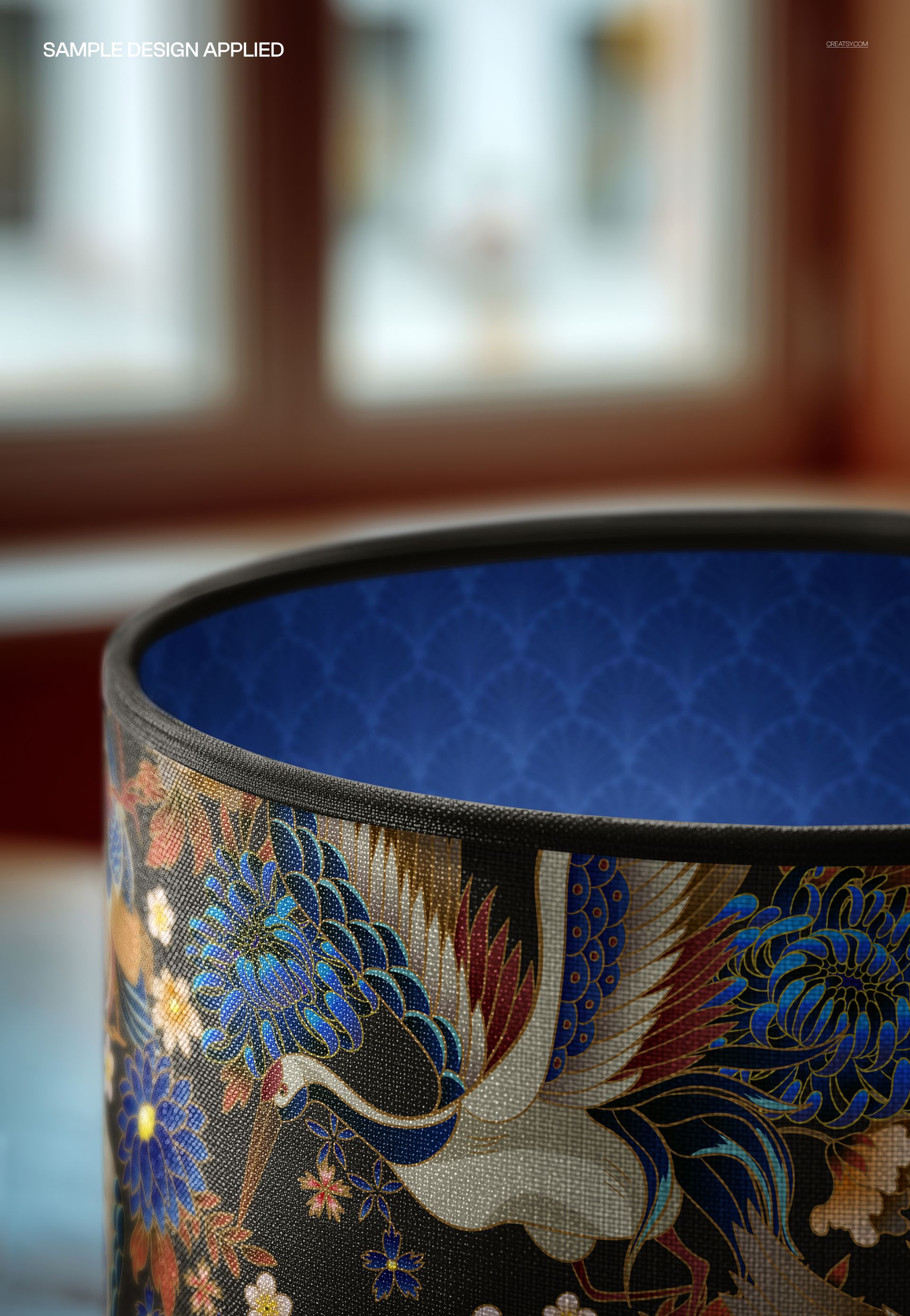 PSD mockup of a cylindrical lampshade with piped rim detail, showing intricate blue and gold crane artwork in a home setting.