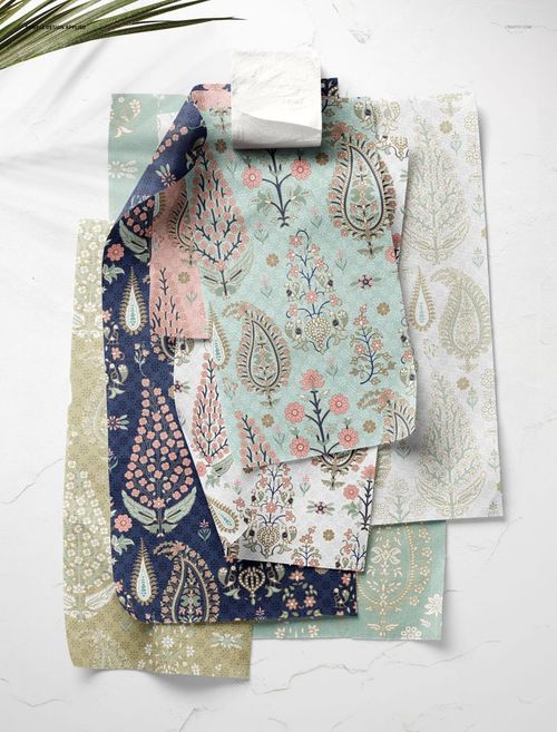 PSD mockup of multiple cotton fabric swatches with intricate patterns, displayed vertically against a light wall.