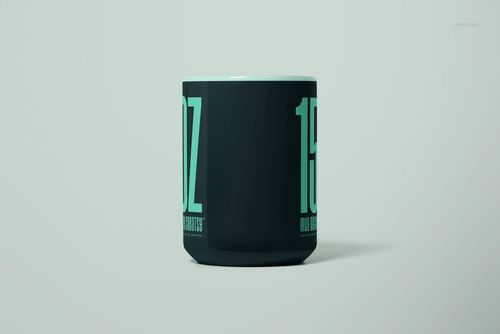 15oz mug mockup with dark body, oversized mint green lettering, and minimalistic studio setting, front perspective.