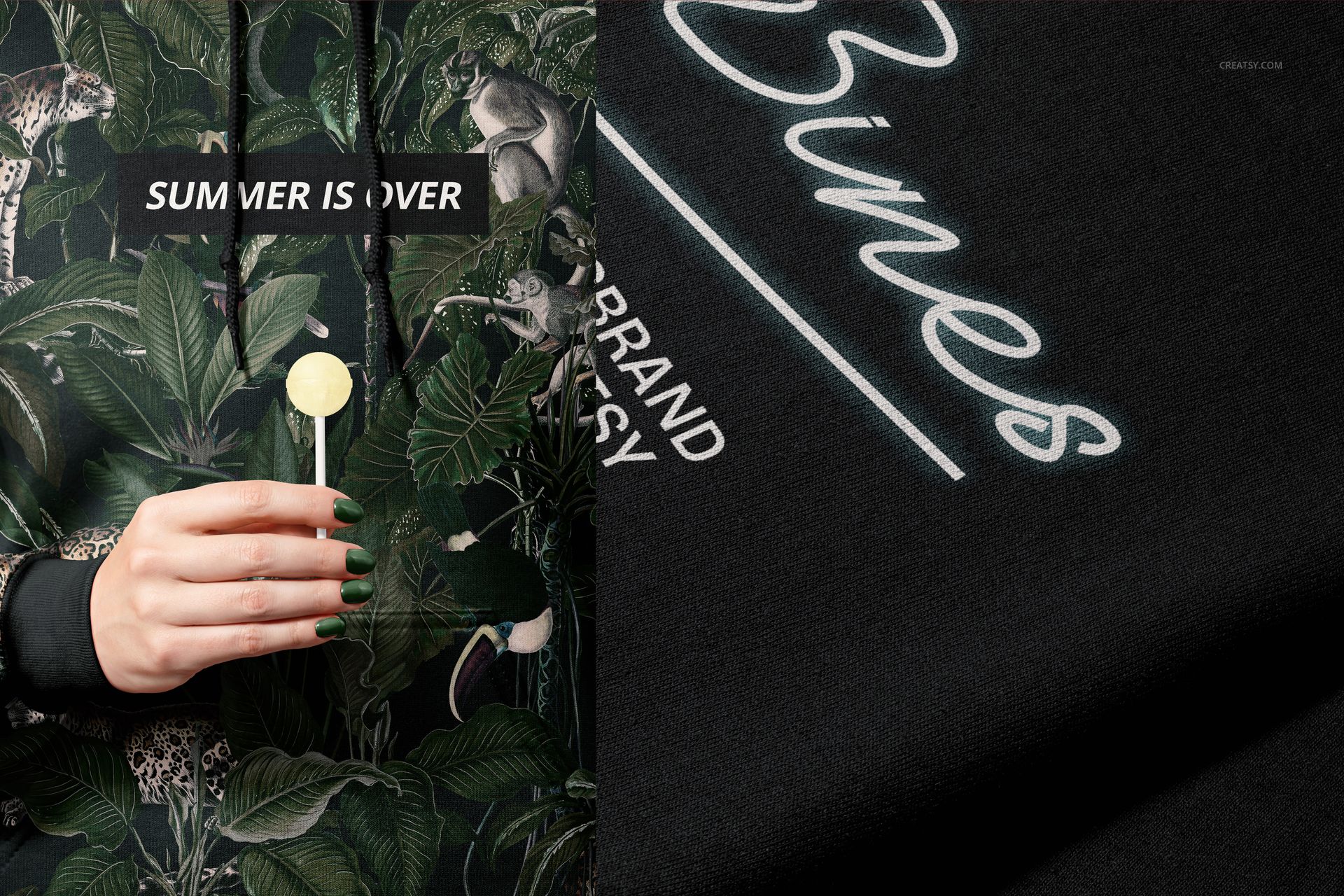Front view of a Gildan 18500 hoodie mockup with a green tropical leaf and animal pattern, person holding lollipop.