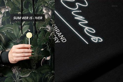 Front view of a Gildan 18500 hoodie mockup with a green tropical leaf and animal pattern, person holding lollipop.