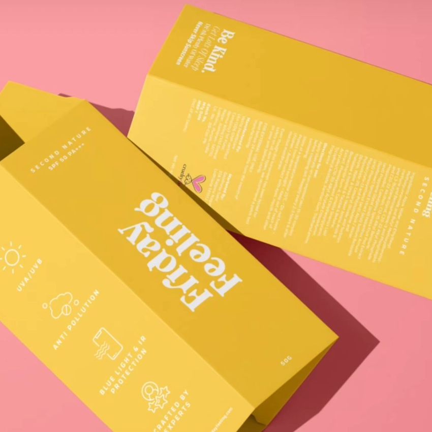 Tall box mockup featuring two yellow rectangular packaging boxes with white text and icons, displayed on a pink background.