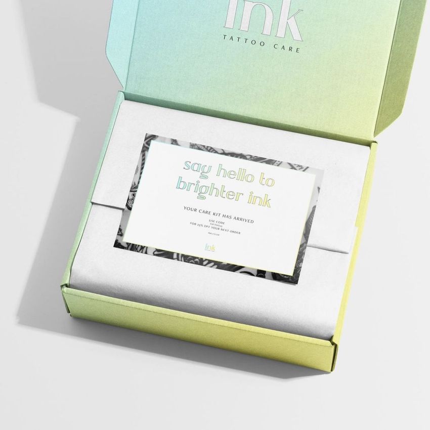 Stationery mockup featuring a pastel gradient box with a card inside, viewed from above on a light background.