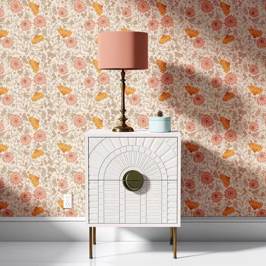 Drum lamp shade mockup with a pink floral pattern, placed on a white nightstand against a matching floral wallpaper.