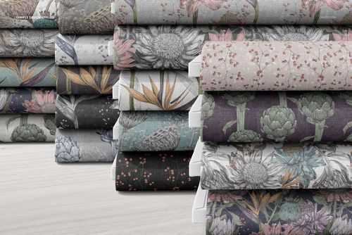 Front view of several fabric bolts with intricate flower and leaf motifs, presented as a PSD mockup on a pale background.