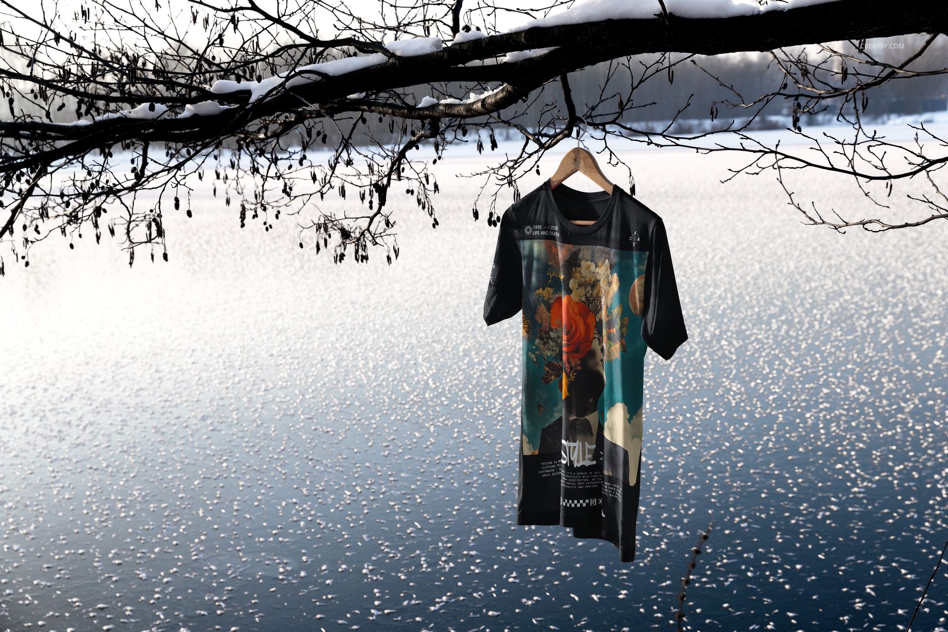 Bella Canvas 3001 t-shirt mockup displayed outdoors, hanging above a wintry lake with snow and ice visible.