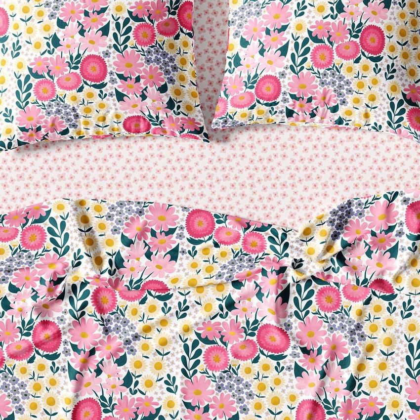 Bedding set mockup featuring a vibrant floral pattern with pink, yellow, and white flowers on a bedspread and pillows.