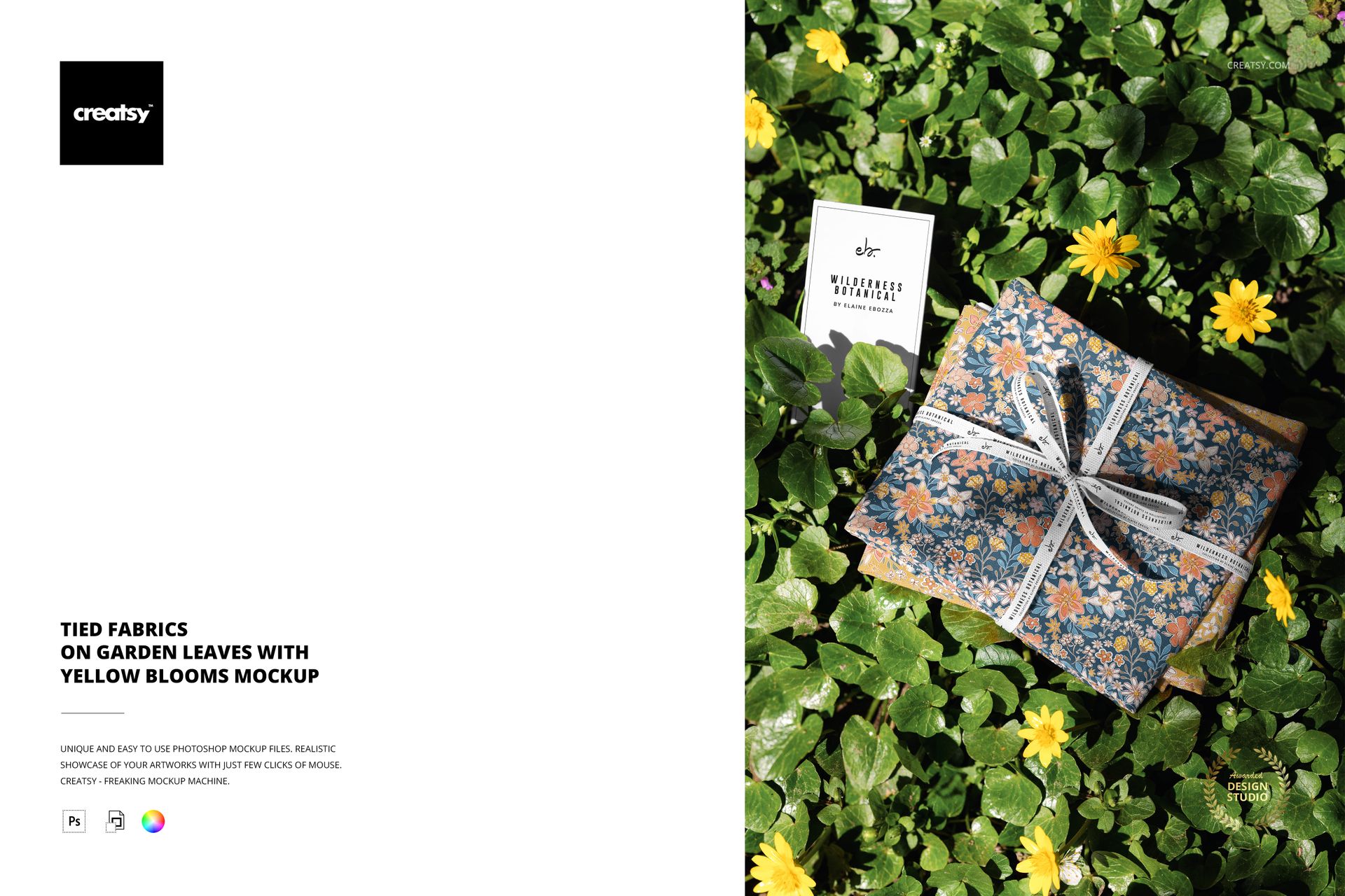 PSD mockup showing a tied fabric bundle with a blue and orange flower design on leafy ground with yellow blossoms.