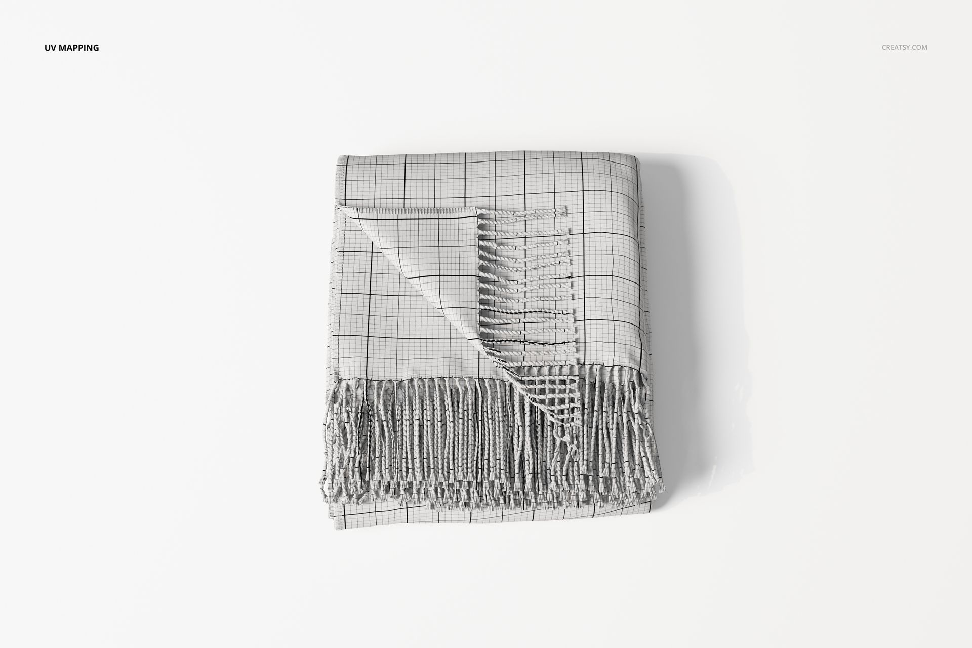 Folded fringe blanket with wrapped corner, featuring a grid pattern and visible tassels, shown from above on a white surface.