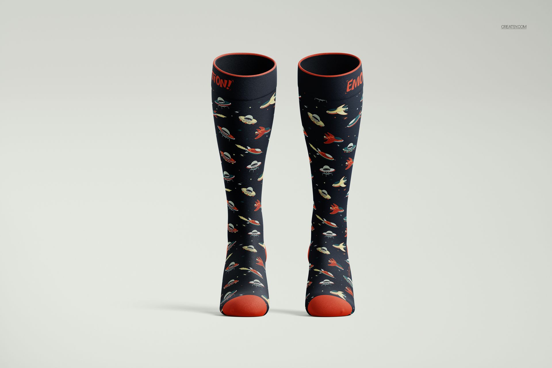 Front view of over the calf socks mockup with dark fabric, red accents, and colorful space-themed pattern on a plain background.