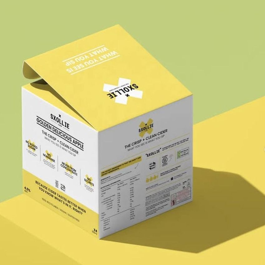 Square box mockup featuring a yellow and white packaging design with printed text and graphics, shown on a light green surface.