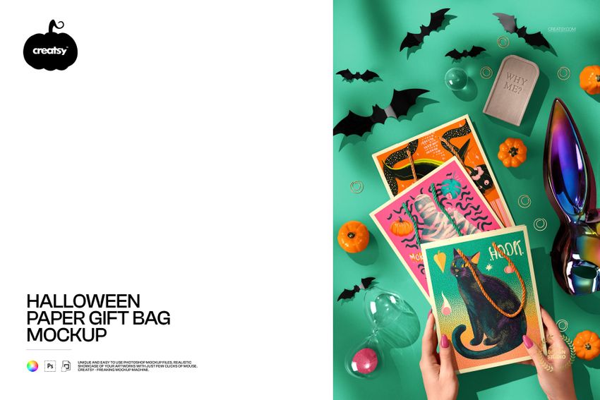 Top view of a Halloween paper gift bag mockup with vibrant designs, pumpkins, bats, and festive props on a green surface.