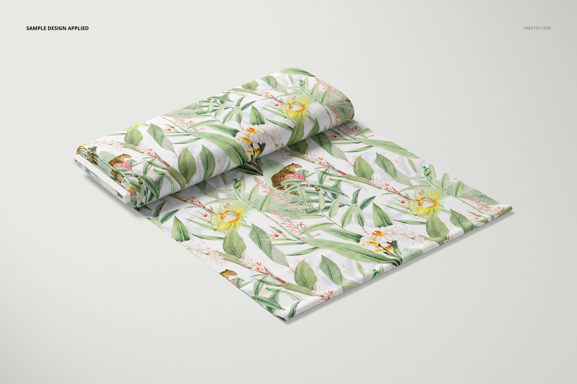 Fabric bolt mockup featuring a folded bolt with tropical leaf and butterfly pattern, displayed on a light background.