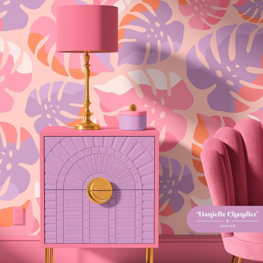 Drum lamp shade mockup with a pink and gold lamp on a lavender nightstand, set against a colorful tropical wallpaper.