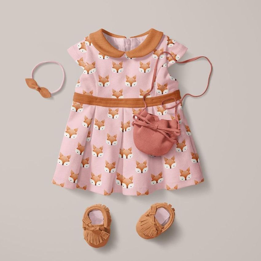 Peter Pan collar baby dress mockup with a pink fox pattern, styled with matching shoes, a headband, and a small bag on a neutral background.