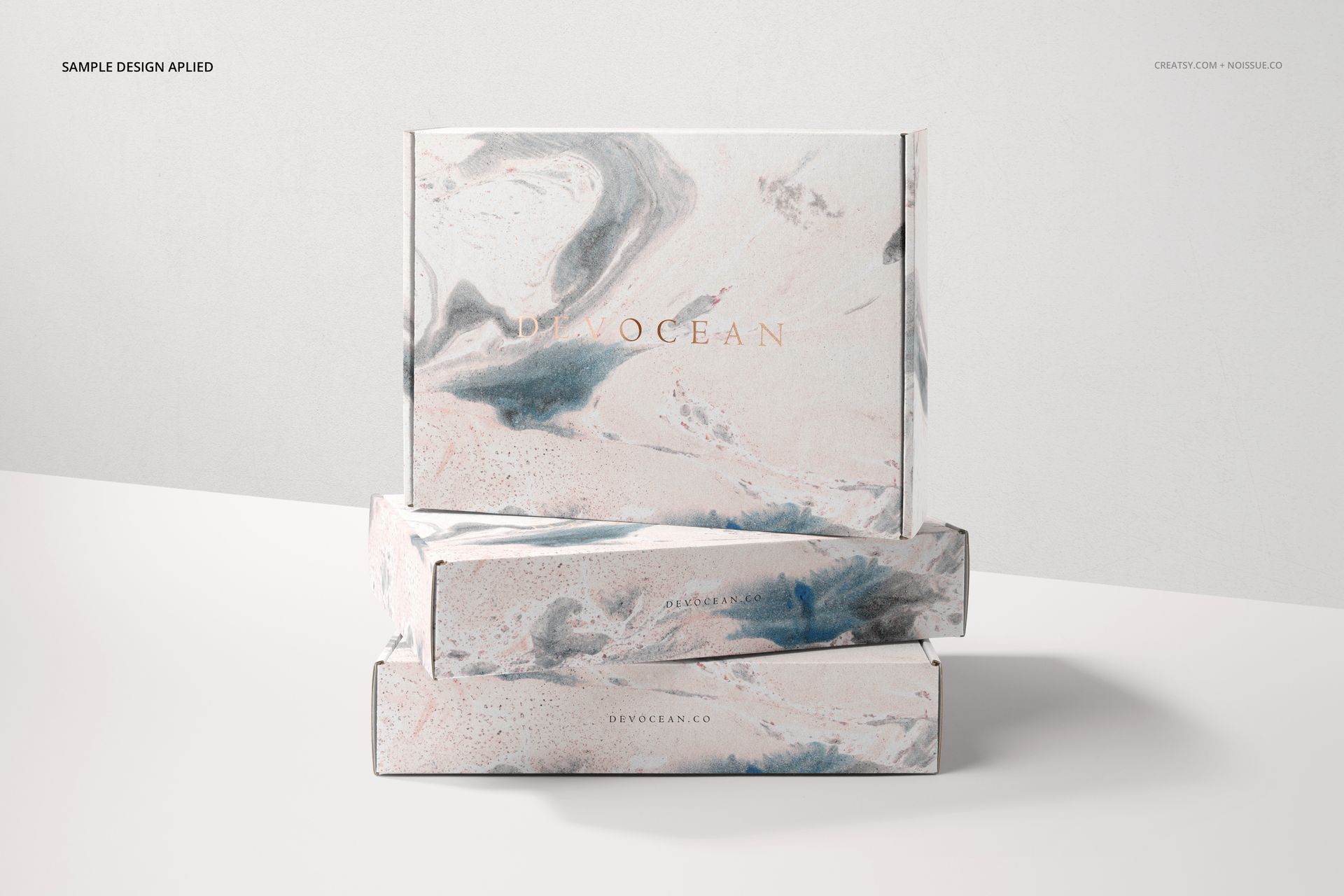 PSD mockup of mailing boxes featuring a light abstract swirl pattern, arranged one atop another on a plain surface.