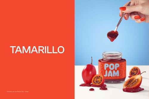 PSD mockup featuring an open jam jar, tamarillo fruit halves, spilled jam, and a hand holding a spoon against a blue backdrop.