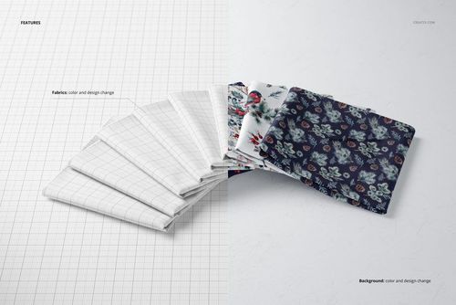 PSD mockup of multiple folded textiles, including white grid and dark floral prints, laid out on a split white and gray surface.