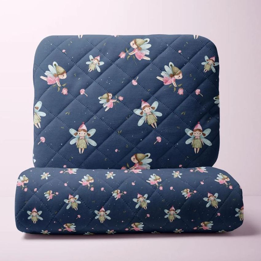 Double-sided baby bedding set mockup featuring a quilted pillow and blanket with a fairy pattern on a soft pink background.