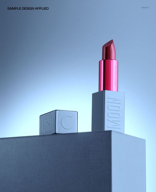 PSD mockup showing a single lipstick on a geometric pedestal with blue gradient background and dramatic lighting.