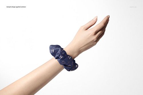 Blue patterned hair scrunchie mockup displayed on a wrist, with a neutral white backdrop and minimal shadows.