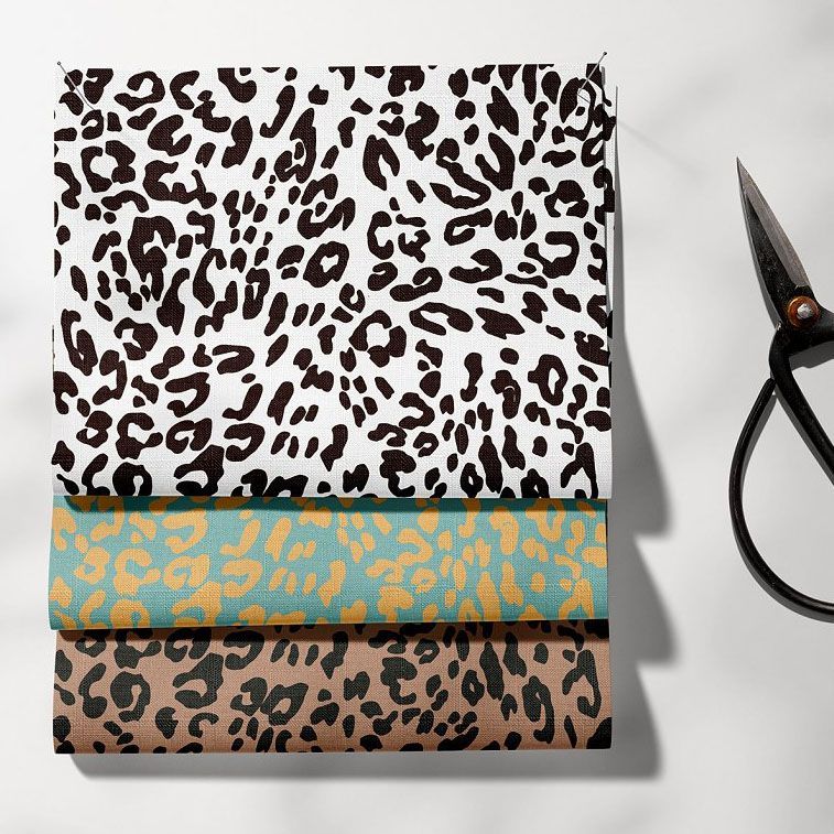 Fabric mockup showing three stacked fabric pieces with animal print patterns in black, teal, and brown tones on a white surface.