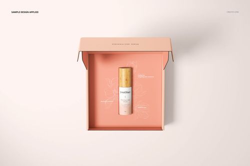 Top view of a peach-colored mailing box mockup with a gold-capped cosmetic bottle placed at the center.