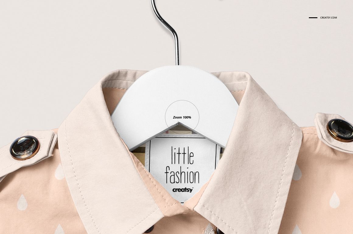 Front view of a baby coat mockup in light peach color with white raindrop pattern, displayed on a hanger against a neutral background.