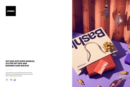 Front view of a gift bag with rope handles, glitter gift box, and business card mockup on a purple surface with festive ornaments.