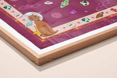 Framed silk scarf mockup featuring space-themed graphics and a cat in an astronaut helmet, shown from an angled perspective.