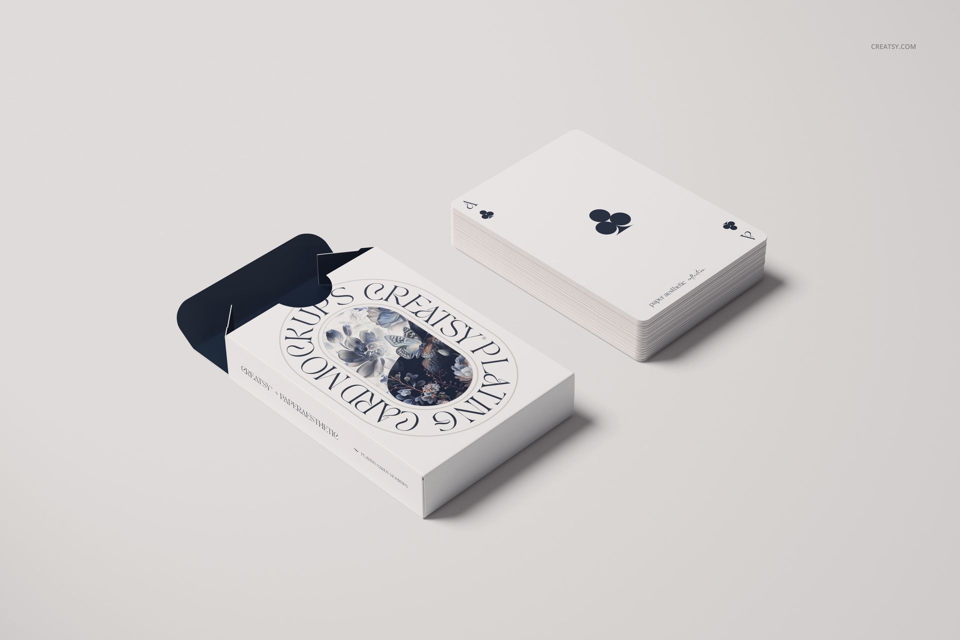 Playing cards mockup featuring an open card box with decorative design and a neat stack of cards on a light surface.