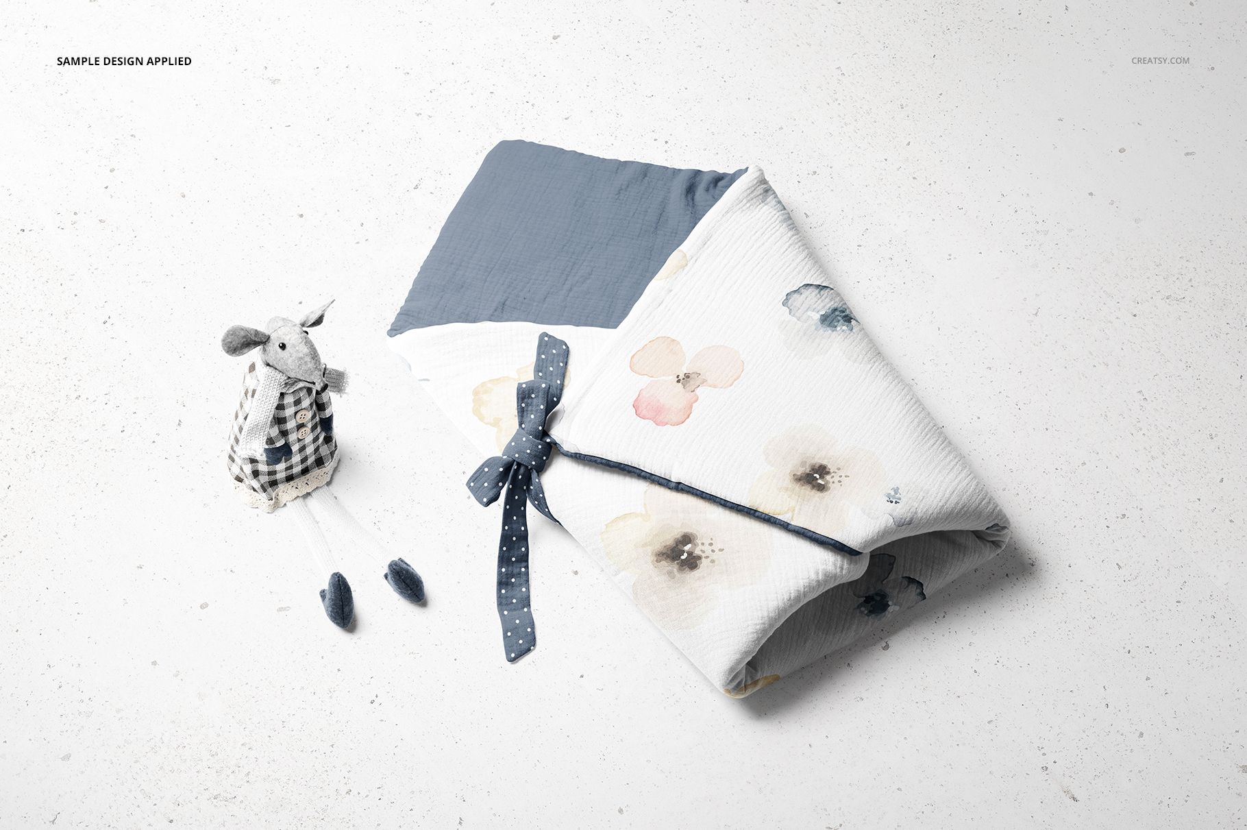 Newborn swaddle wrap mockup set featuring a soft toy rabbit with plaid outfit and baby shoes on a light background.