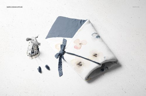 Newborn swaddle wrap mockup set featuring a soft toy rabbit with plaid outfit and baby shoes on a light background.