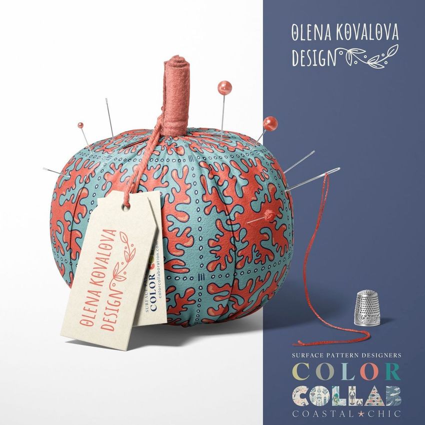 Fabric pumpkin mockup featuring a blue and red patterned textile, sewing pins, a spool of thread, and a thimble on a light background.