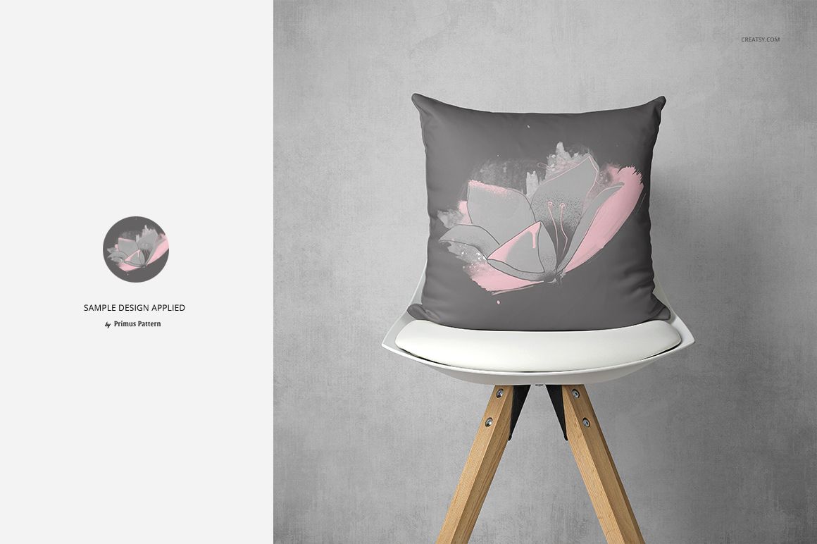 Fabric Factory pillow mockup featuring a gray pillow with pink butterfly artwork, placed on a modern chair.