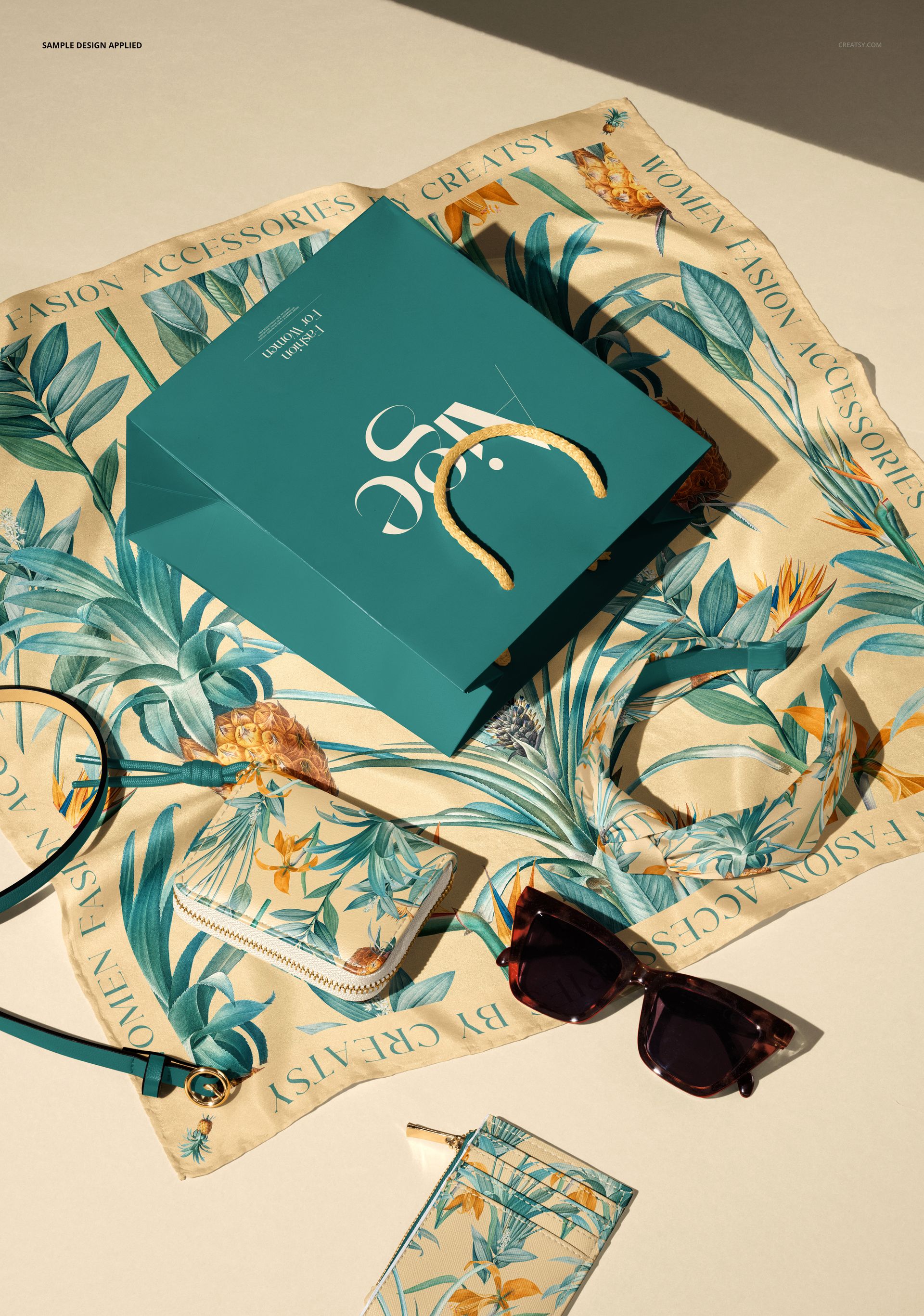 Flat lay of fashion accessories mockup with a teal bag, tropical print scarf, sunglasses, wallet, and cardholder arranged stylishly.