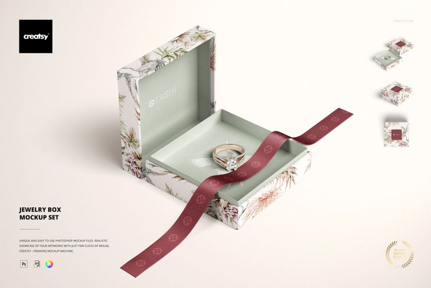Jewelry box mockup featuring a square box with botanical design, open to show a ring and decorative ribbon.
