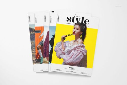 A4 magazine mockup set featuring four magazines fanned out on a white surface, showing colorful cover designs.