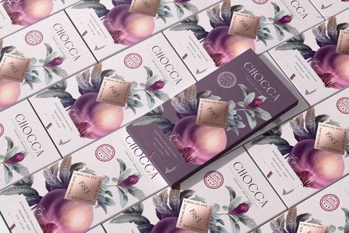 Chocolate bar packaging mockup with purple and peach fruit illustrations, shown in a diagonal repeating layout.