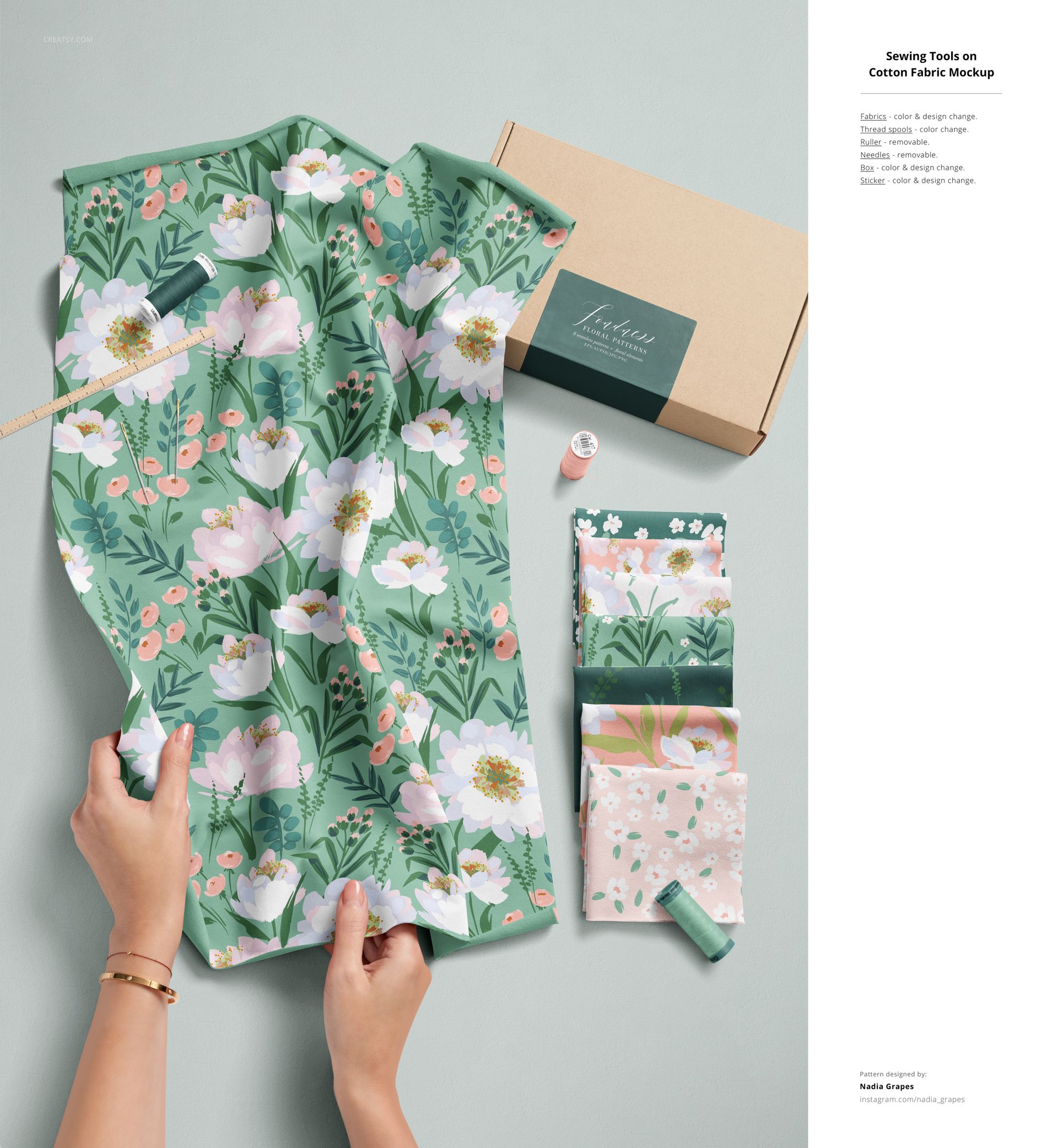 Jersey fabric mockup with floral pattern in green and pink, shown with sewing tools and folded fabric pieces, top view.