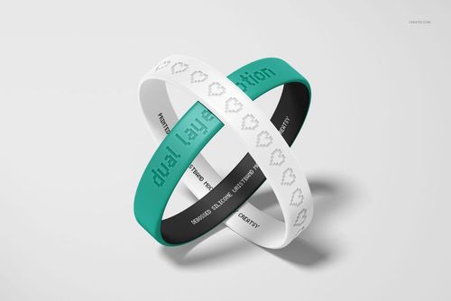 Mockup of teal and white silicone wristbands with debossed text, arranged in an intersecting display on a plain surface.
