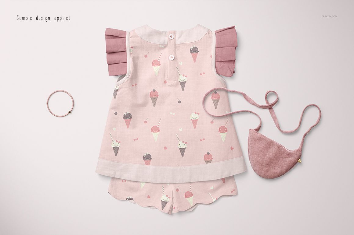 Baby blouse and shorts set mockup with pink ice cream pattern, front view, displayed with matching headband and purse.