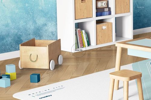 Kids room carpet mockup showing a rectangular white carpet on wooden floor, near wooden toys and furniture.